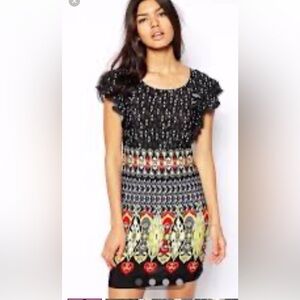 Black summer dress with red, white and yellow motifs.